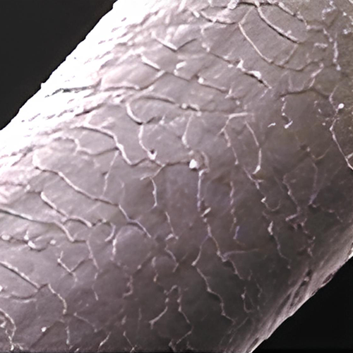 a close up of a white substance on a black background