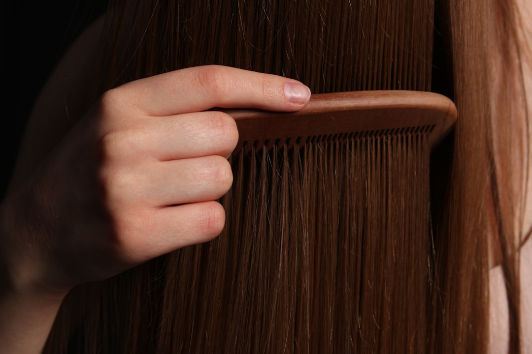 Woman applying invisible wire hair extensions