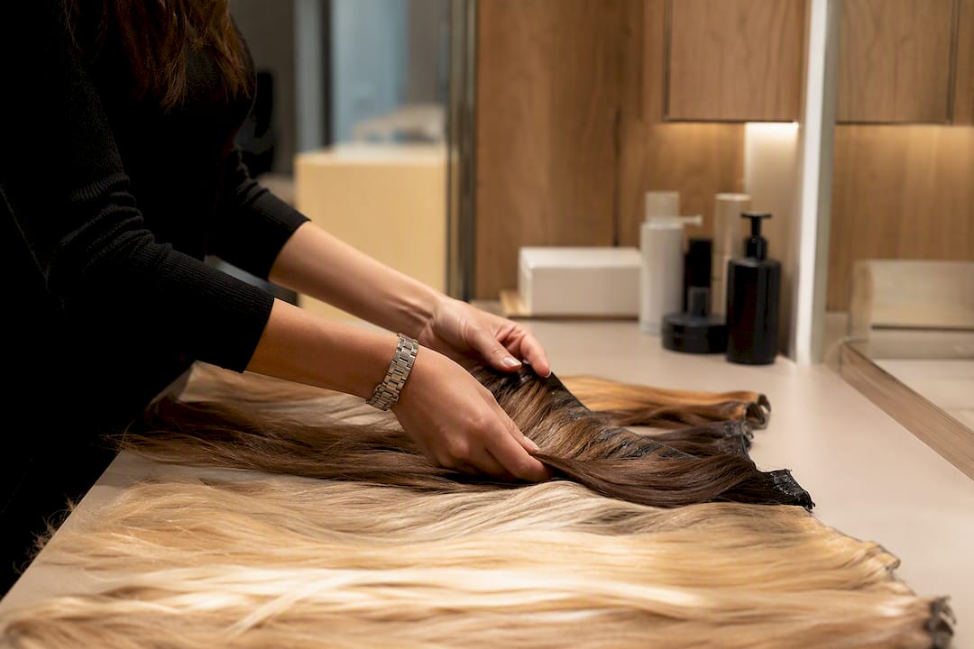 Hairstylist preparing hair extensions close-up